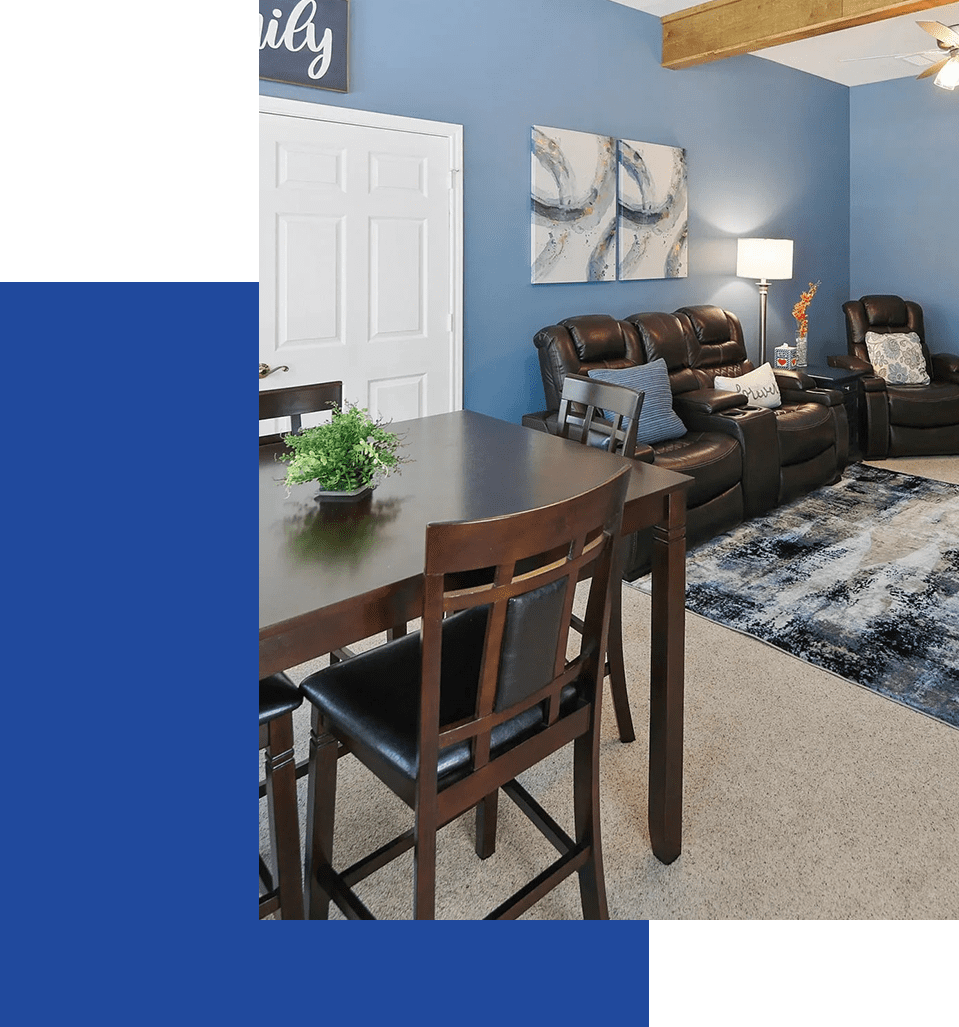 A living room with blue walls and brown furniture.