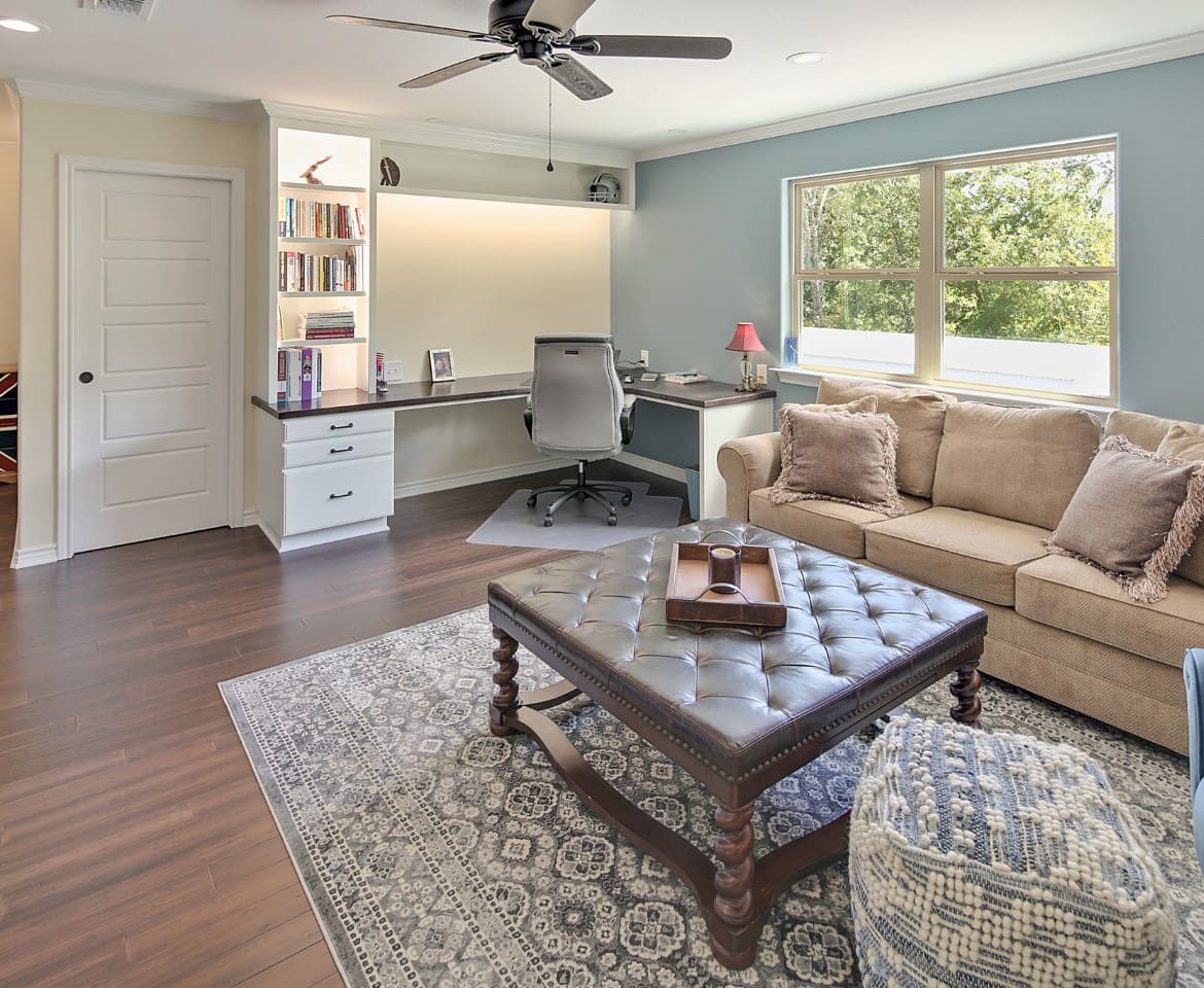 A living room with a couch, table and chair.