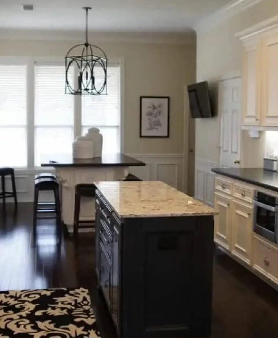 A kitchen with a large island and a dining table.