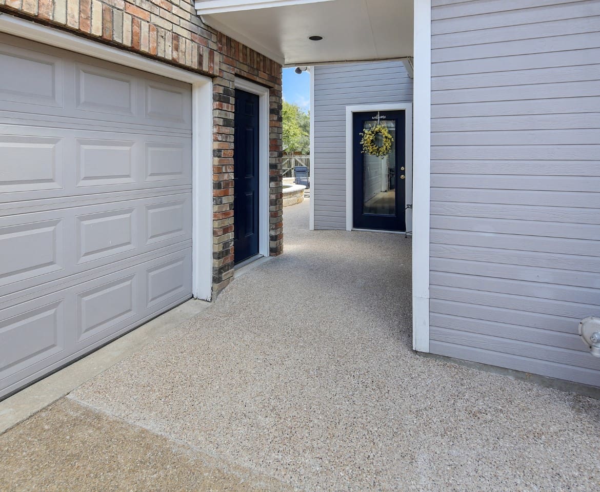 A garage door is open and the front of the house has been painted.