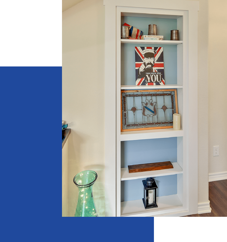 A bookcase with a clock and other items on it.