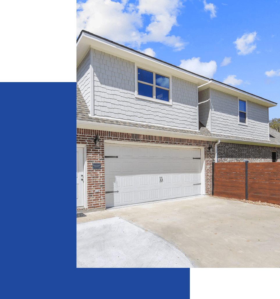 A garage with two doors and a driveway.