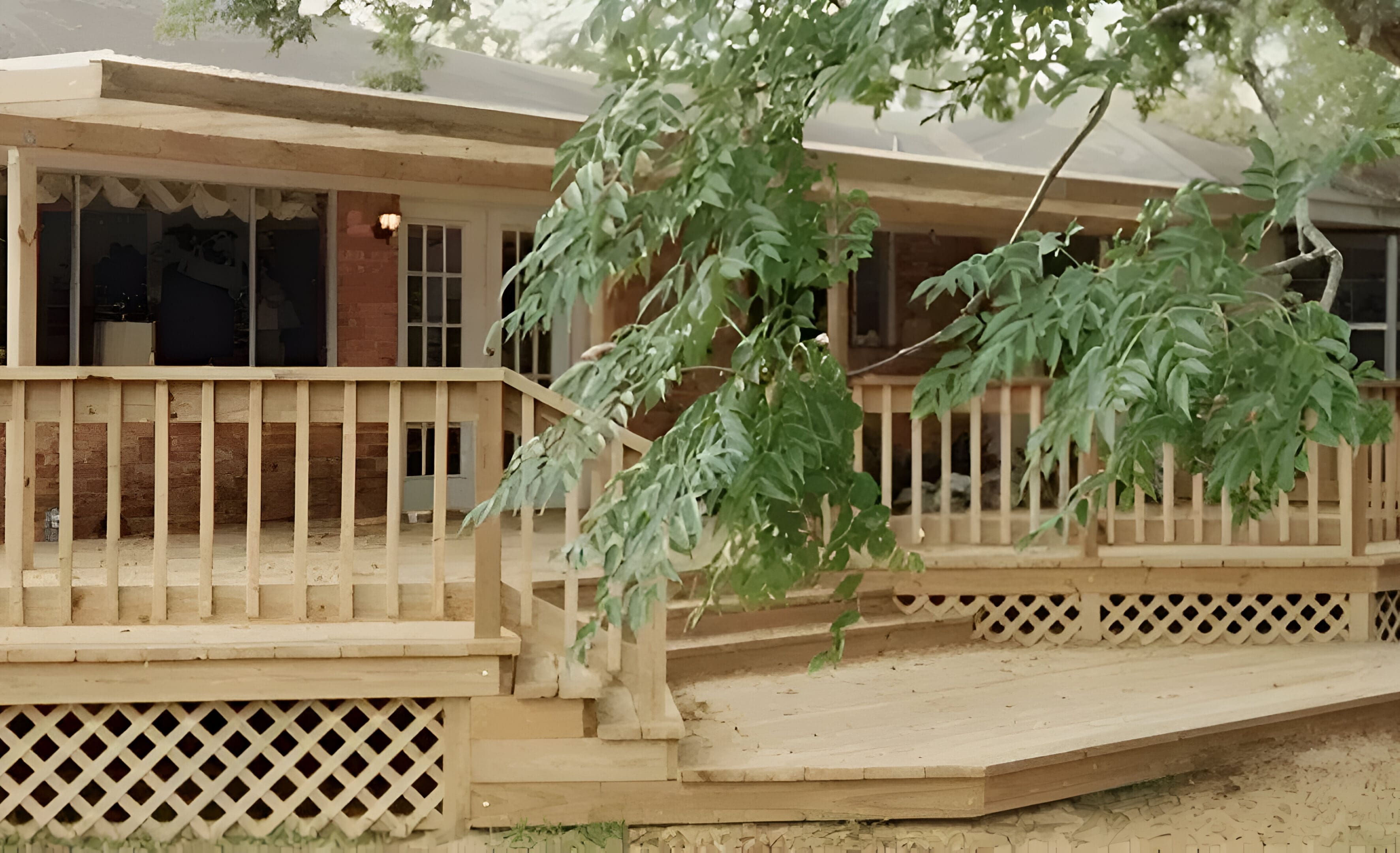 A large tree in front of a house.